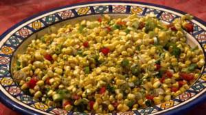Colorful corn salad in decorative ceramic bowl.