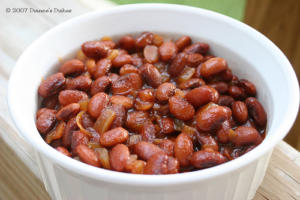 Bowl of baked beans with onions.