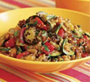 Colorful vegetable stir-fry in yellow bowl.