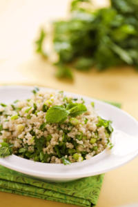 Quinoa salad with fresh herbs on plate.