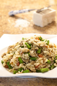 Risotto with asparagus and mushrooms on plate.