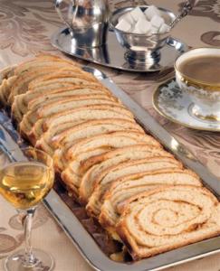 Sliced pastry with coffee and sugar cubes.