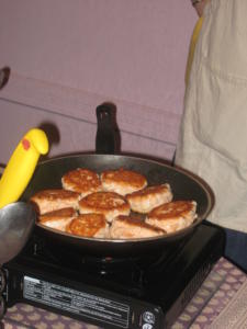 Pan-frying patties on a stovetop.