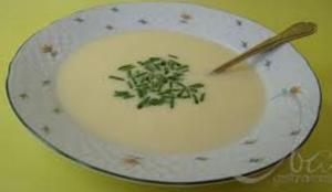 Creamy soup garnished with chopped herbs.