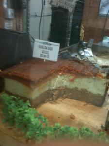 Layered kugel slice with price sign display.
