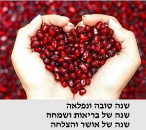 A person holding pomegranates in their hands