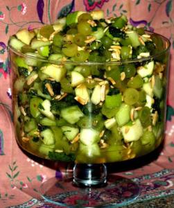 Green fruit salad in a glass bowl.