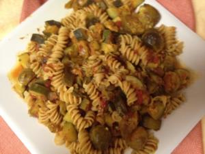 Pasta with vegetables on a white plate.