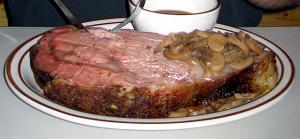 A close up of a plate with meat and gravy
