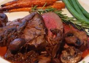 Roast beef with vegetables and mushrooms.