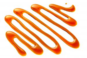 A close up of orange liquid drizzled on top of each other.