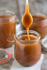 A jar of sauce is being poured into it.