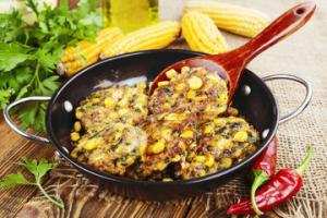 A pan of food with corn and other vegetables.