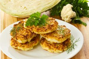 Crispy cabbage fritters on white plate