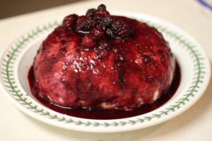 Berry dessert topped with mixed berries sauce.