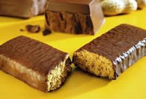 Chocolate peanut bars on yellow background.
