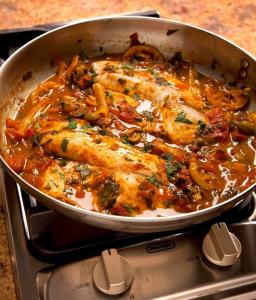A pan of food on the stove top.
