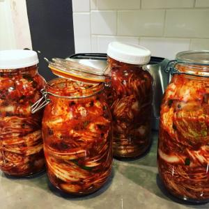 A group of jars filled with food on top of a table.