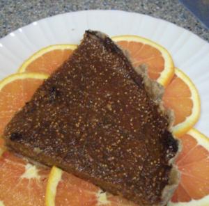 Pie slice on orange slices, white plate.