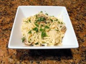 Pasta with herbs in a white bowl.