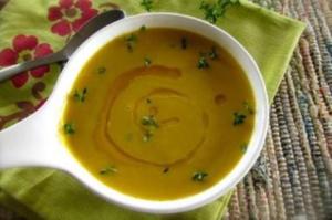 Bowl of soup with garnish on napkin.