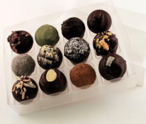 Assorted chocolate truffles in a clear box.