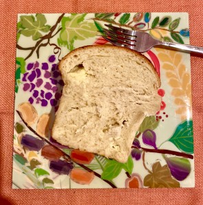 A piece of bread on top of a paper plate.