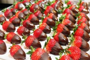 Chocolate-covered strawberries arranged in neat rows.