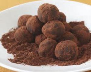 Chocolate truffles dusted with cocoa powder.