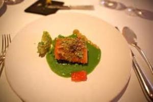 Gourmet dish with green sauce and garnish.