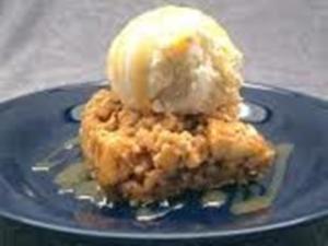 Apple crumble with ice cream on plate.