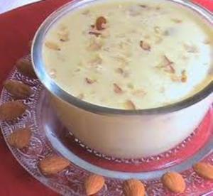 Bowl of almond garnished dessert.