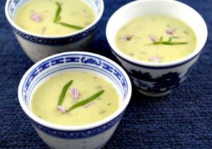 Three bowls of creamy soup with garnish.