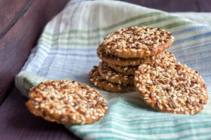A pile of cookies sitting on top of a green and white towel.