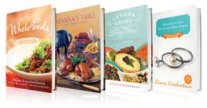 A group of four cookbooks on display.