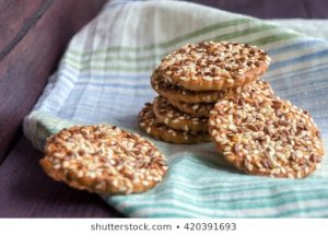 A stack of cookies on top of a green and white towel.
