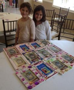 Two girls with decorated picture frames.