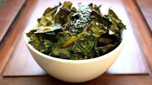 White bowl of crispy kale chips