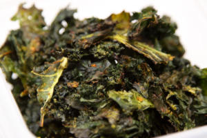Bowl of crispy seasoned kale chips.