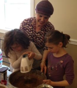 Children baking with guidance from an adult.