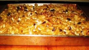 Baked noodle casserole in a metal pan.