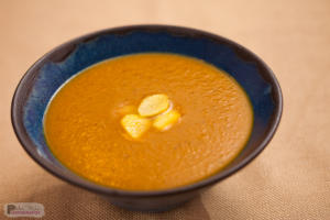 Bowl of pumpkin soup with croutons.