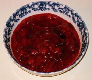Bowl of cranberry sauce on table.