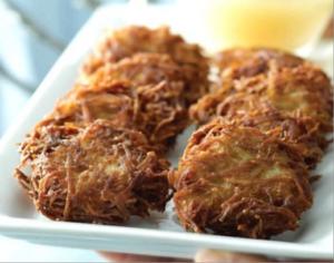 Crispy shredded potato latkes on white platter