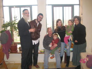 Group of people posing indoors near windows.