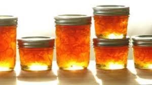 A group of jars filled with honey on top of a table.