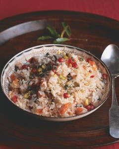 A bowl of food on top of a wooden table.