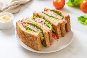 A sandwich cut in half on top of a plate.