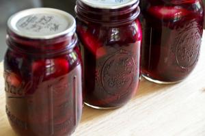 Three jars of jam on a table.