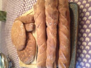 Assorted homemade bread on patterned tablecloth.